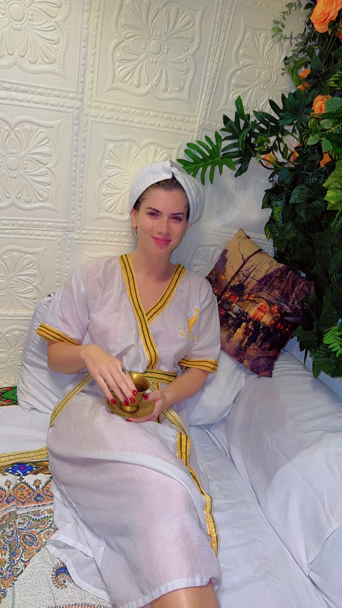 Guest relaxing in a Liya robe with a cup of tea